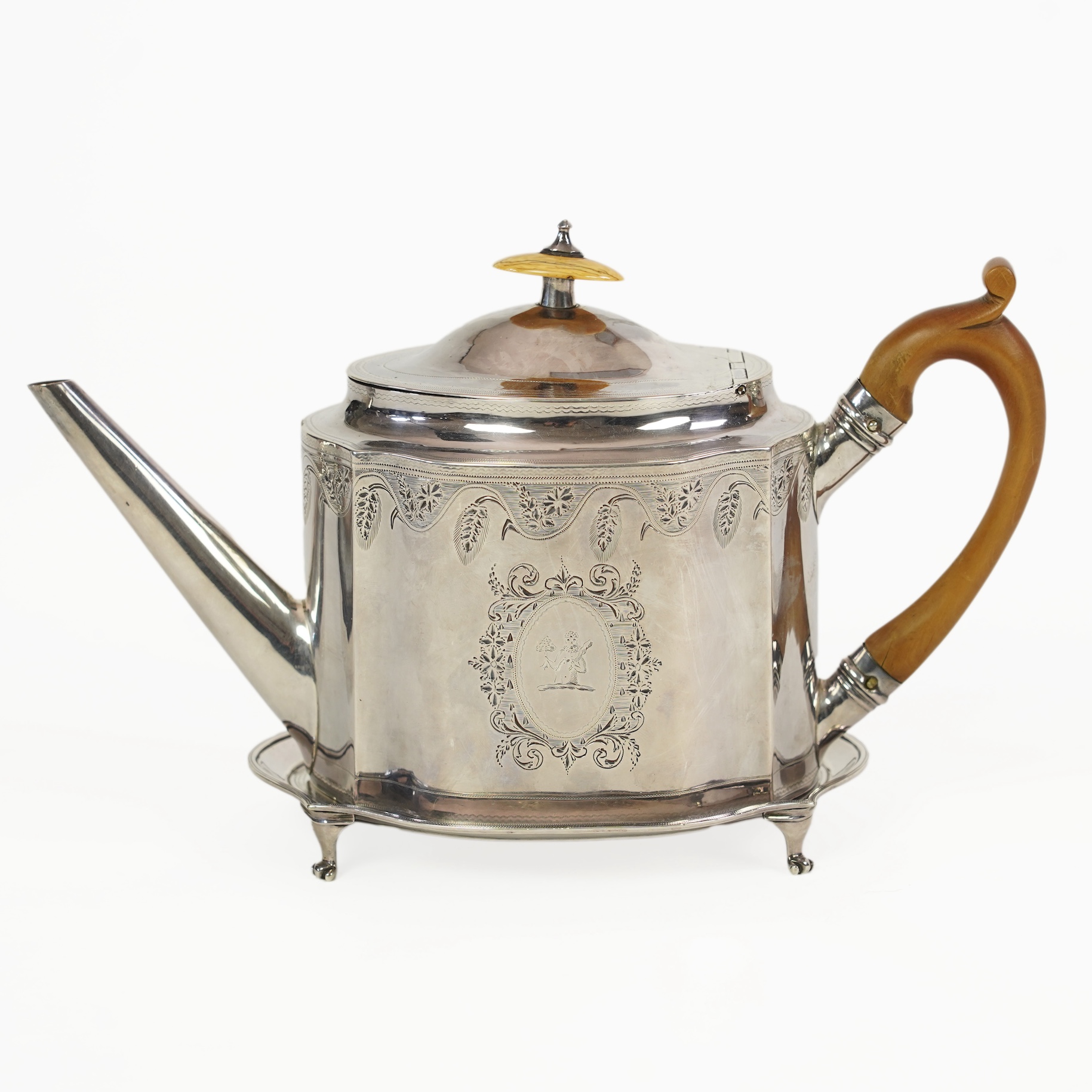 A George III silver teapot and matching stand, by Soloman Hougham